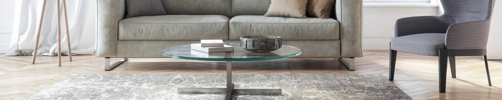 Living room with a gray couch and area rug on hardwood flooring from Scott's Flooring in Barrie, ON