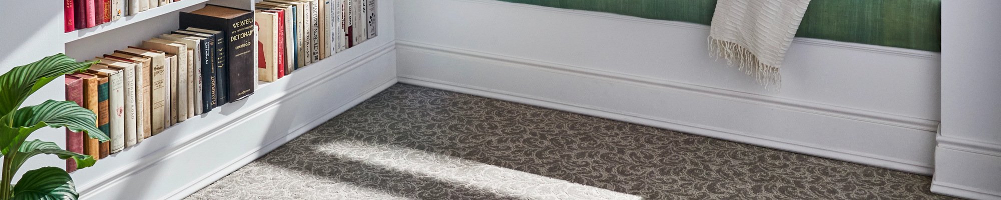 Person reading in window in a room with gray patterned carpet from Scott's Flooring in Barrie, ON