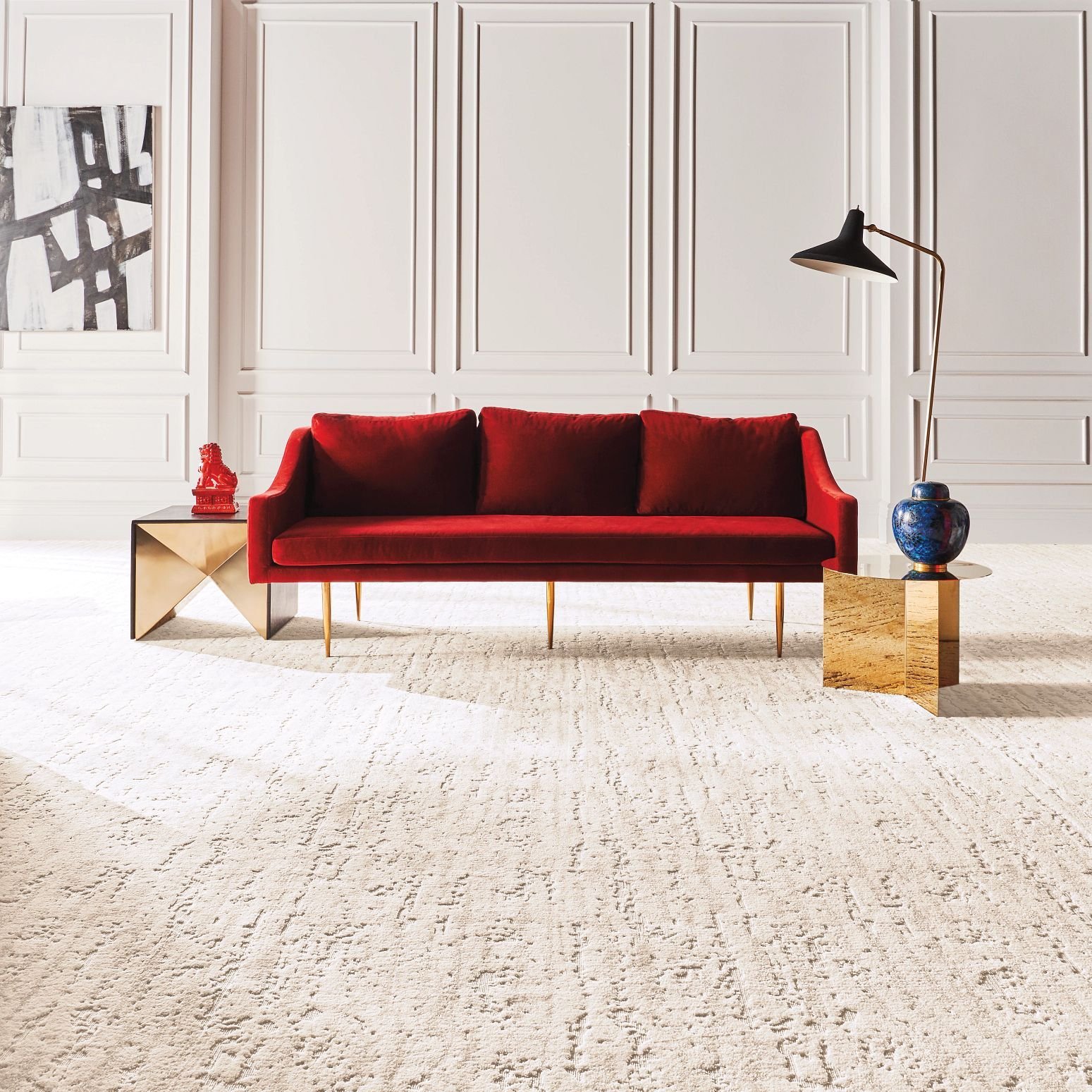 Bright living room with red velvet couch and beige textured carpet from Scott's Flooring in Barrie, ON