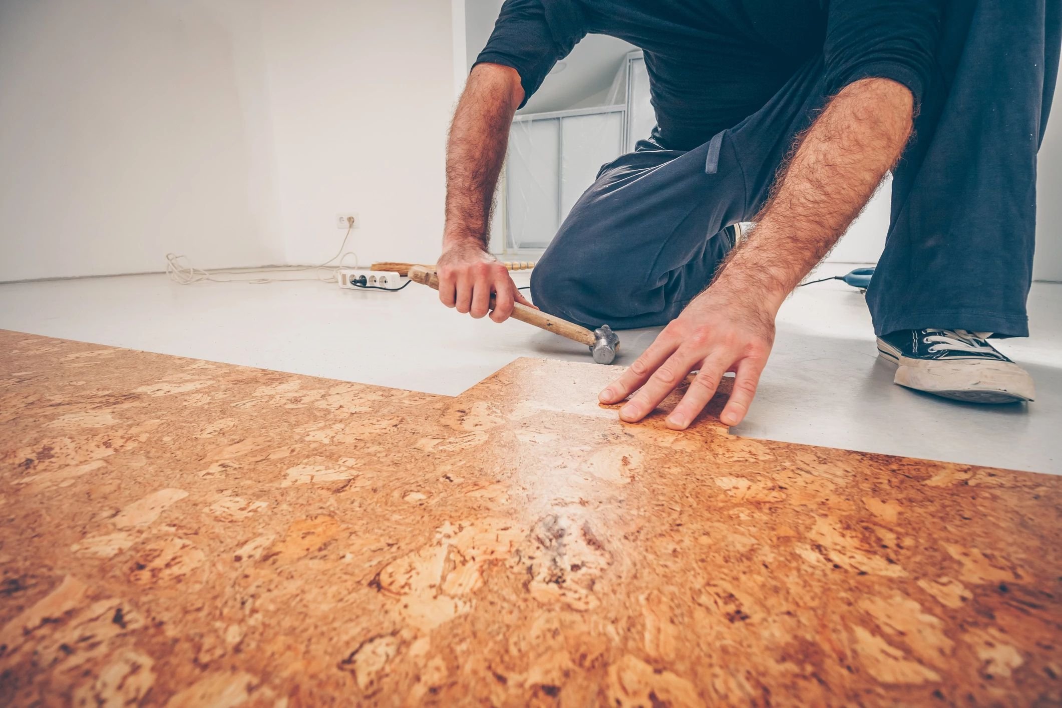 Person installing cork flooring from Scott's Flooring in Barrie, ON
