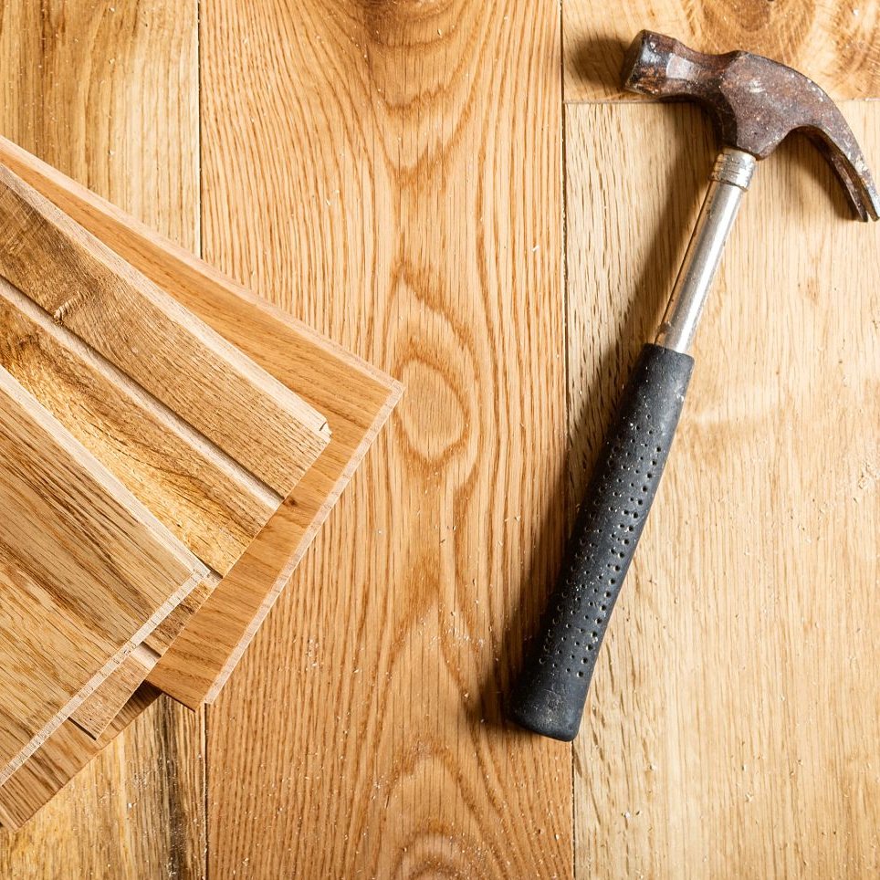 Hammer on a hardwood floor - Flooring installation services from Scott's Flooring in Barrie, ON